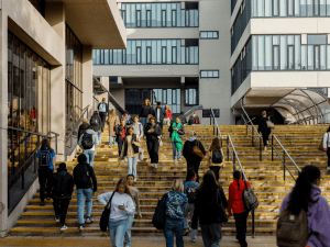 Students walking on steps outside buildings