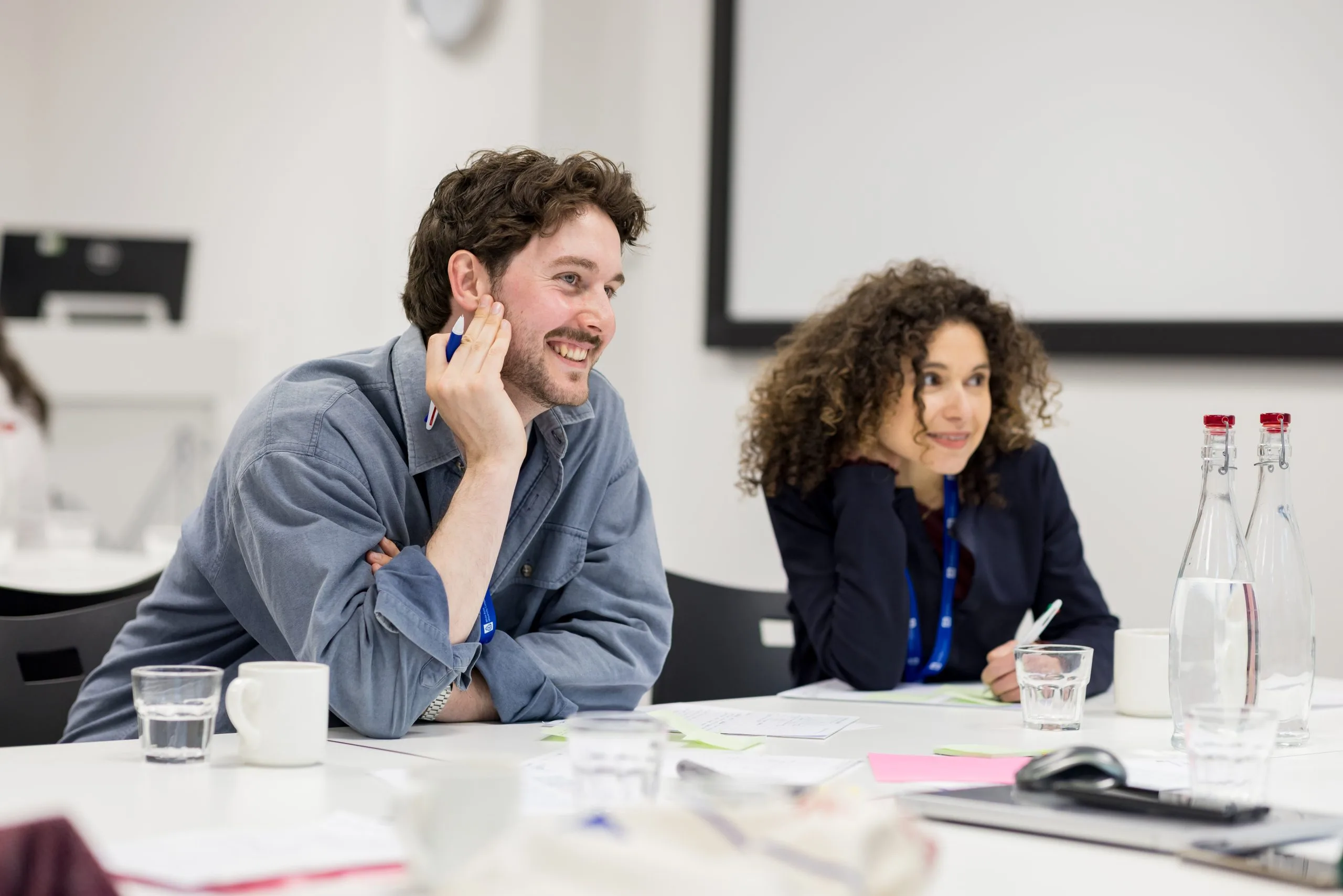 A man and a woman sat at a desk