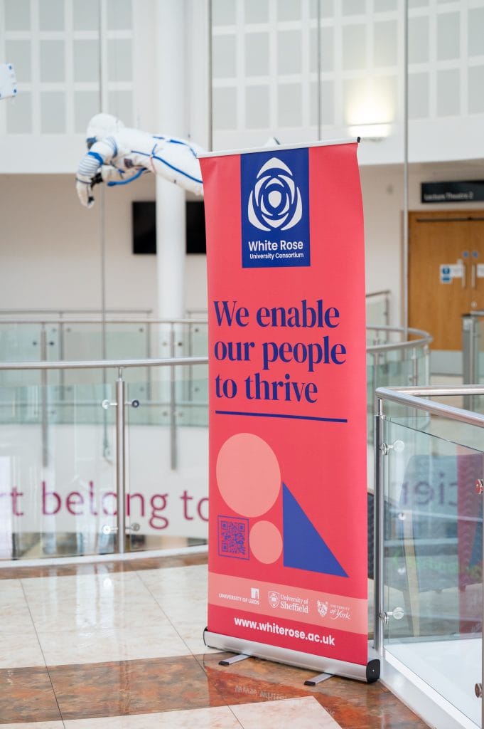 _SKY8544 A pink White Rose branded banner which says 'We enable our people to thrive'