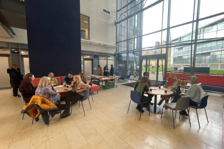 Delegates at the Women Connect conference sitting at roundtables talking