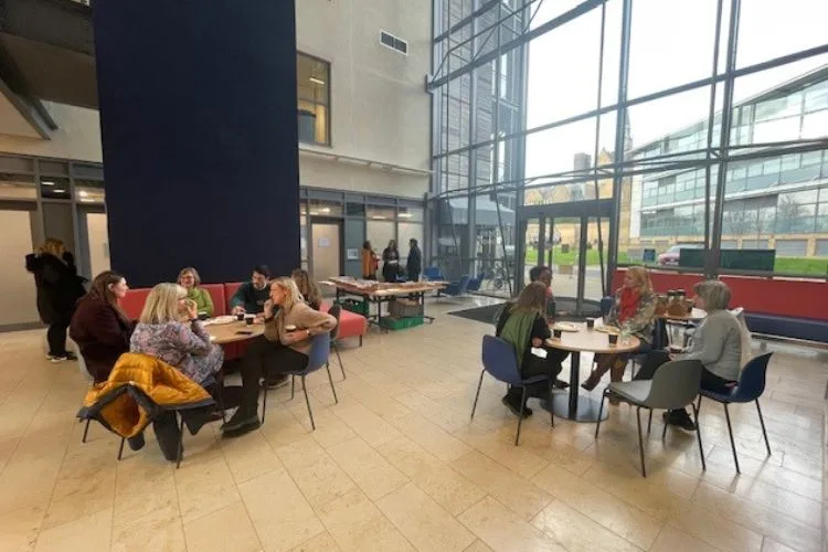 Delegates at the Women Connect conference sitting at roundtables talking