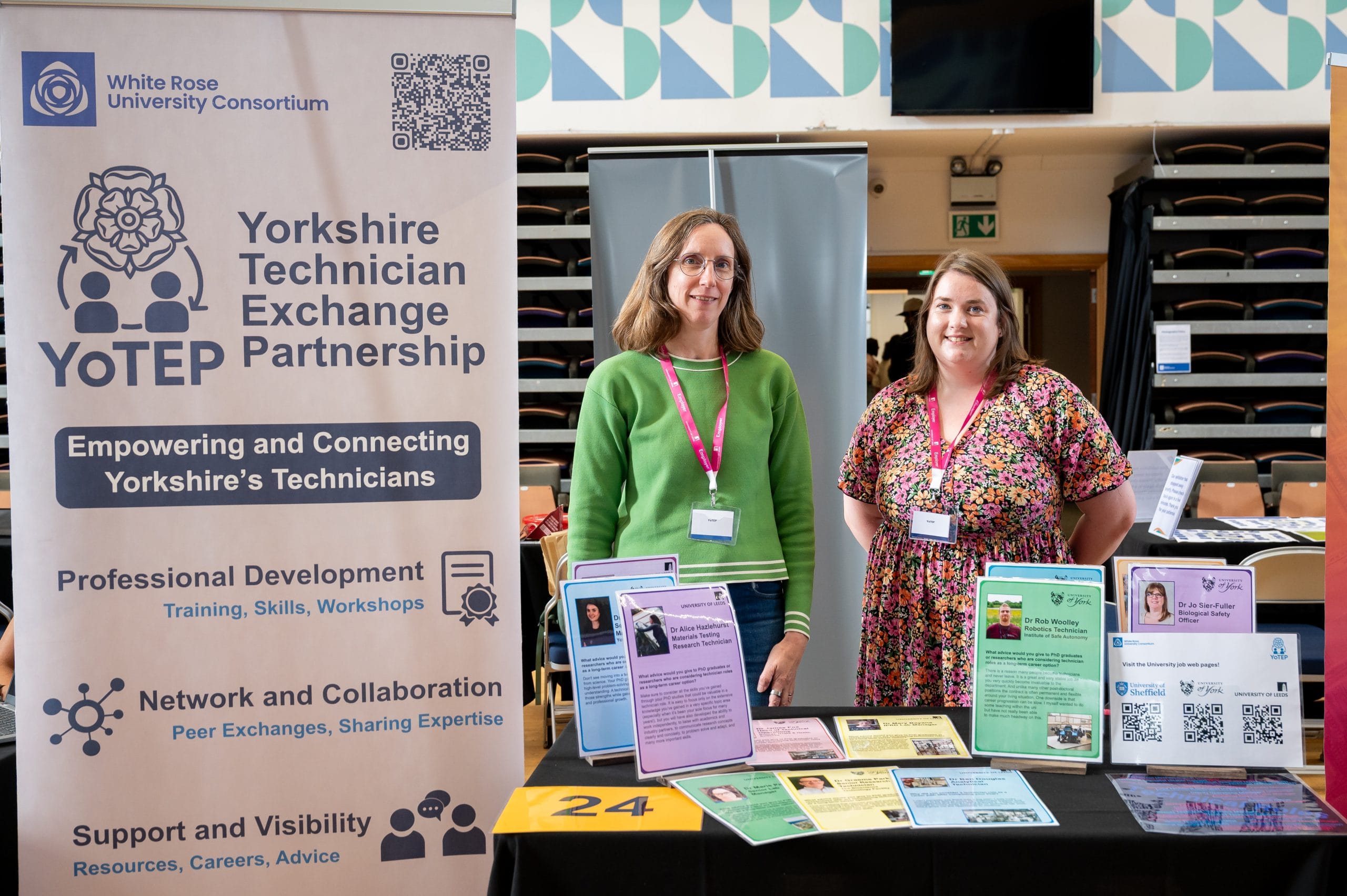 Two people smiling in front of a banner that reads 'Yorkshire Technician Exchange Partnership'