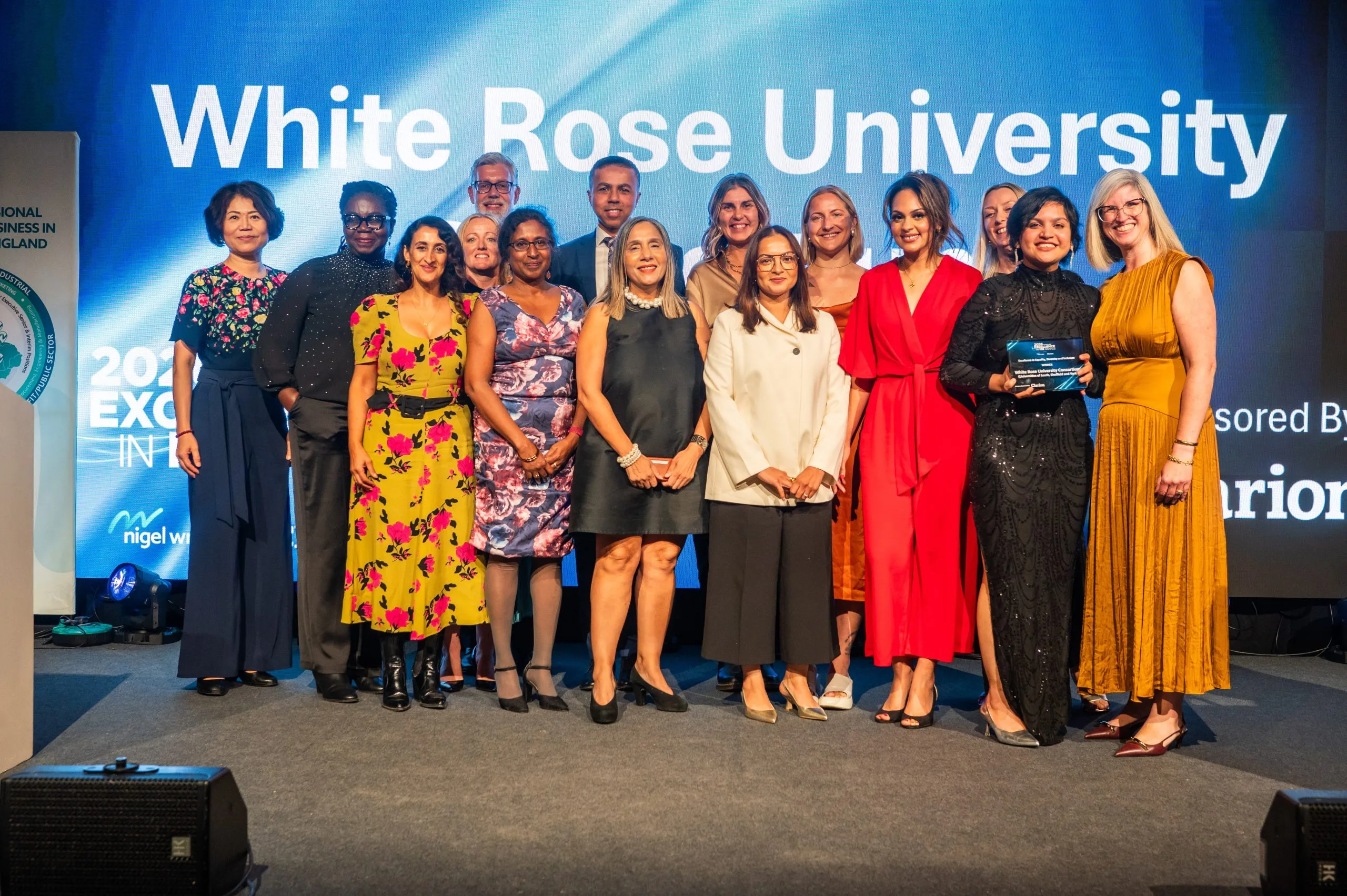 Group of people on stage holding award