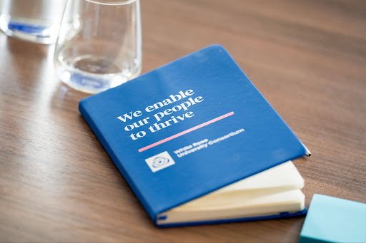 blue book on table next to glass of water